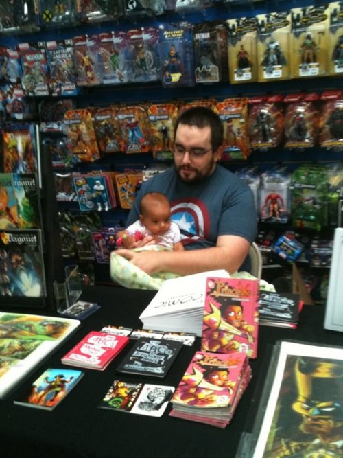 Jeremy Whitley with his daughter in a comic book store